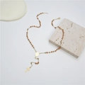 Detailed close-up of orange bead rosary necklace with gold cross and lobster clasp - Orange Red (Style 8)