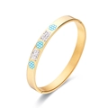 Elegant gold plated stainless steel bangle featuring blue enamel flowers and pavé crystals - Gold