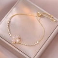 Bracciale tennis dorato con quadrifoglio in zircone rosa a cuore e chiusura regolabile - Stile Quadrifoglio (TS0087) / Rosa
