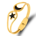 Detailed close-up of gold stainless steel bangle with black enamel star and moon charms - Gold Black