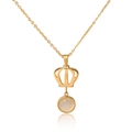 Elegant gold hollow crown necklace with a white moonstone pendant on a white background - Gold Tone White Gemstone