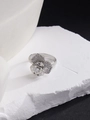 Close-up of silver rose ring with pavé crystals on a white stone background - Exquisite Flower (JZ170)
