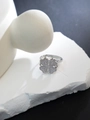 Macro shot of a silver four-leaf clover ring with micro-pave crystals on stone stand - Full Zirconia Clover Style (JZ85) / Silver