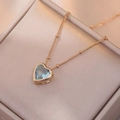Détail macro d'un collier pendentif cœur en zircon bleu dans un écrin or rose - Collier Cœur Bleu Clair (Avec Pendentif)
