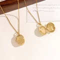 Gold star oval locket necklace with sparkling stones shown in open and closed views - Oval Star Branch Gold Style (XL4688)