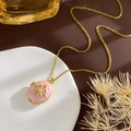 Vintage locket necklace with pink enamel and gold star detail on a ceramic dish - Cross Star Locket (Gold Pink)