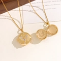 Gold locket necklace with sparkling crystal angel wing pattern and photo compartment - Spreading Eagle Locket
