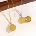 Golden round locket necklace featuring engraved palm and white zircon details - Hand Locket