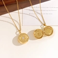 Golden round locket necklace with star engraving and open photo compartment detail - Star Locket