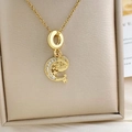 Golden necklace with star and moon charms and crystal details in a leather jewelry box - Moon Star Necklace Gold (XL1816)