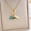 Golden travel theme necklace featuring passport, airplane and luggage tag pendants - Airplane Passport Necklace (XL1913) / Gold