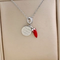 Silver necklace with engraved circular pendant and red chili charm with crystal accents - Silver