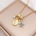 Golden ocean theme necklace featuring shell, blue starfish, and pearl charms - Shell Sea Star (XL4492) / Gold