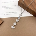 Silver multi-charm necklace with moon, heart, and butterfly zircons on wooden background - XL5142 Heart Butterfly Tassel Necklace / Silver