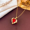 Golden heart necklace featuring a large red gemstone with a sparkling crystal border - Necklace / Red-Gold