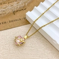 Pink heart crystal necklace with golden flower detail and sparkling stone accents - Necklace / Gold / Pink