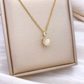 Golden flower spinning opal necklace with sparkling crystal halo on elegant jewelry stand - Rotating Round Style Gold Small (XL349)
