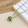 Elegant gold chain necklace with a deep green heart crystal and pavé flower detail - Necklace / Gold / Green