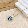 Elegant gold necklace featuring a heart-shaped blue crystal and a small golden flower - Necklace / Gold / Light Blue