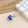 Elegant heart-shaped blue crystal necklace with silver floral accents and zircon stones - Necklace / Silver / Sapphire Blue