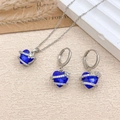 Elegant silver jewelry set featuring a deep blue heart-shaped necklace and drop earrings - Necklace and Earring Set / Silver / Sapphire Blue