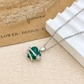 Silver heart necklace with emerald green gemstone and small flower accent charm - Necklace / Silver / Green