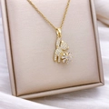 Gold rotating teddy bear pendant necklace with sparkling crystal inlay on silk - Gold