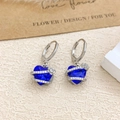 Silver flower earrings with blue heart-shaped crystal and sparkling diamond accents - Ear Buckle / Silver / Sapphire Blue