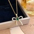 Elegant gold bow necklace featuring green crystal and white cubic zirconia accents - Green Stone Bow Style (XL1770) / Gold