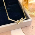 Elegant gold titanium steel necklace featuring a zircon-encrusted bow pendant on a jewelry box - Double Loop Bow Style (XL5254) / Gold