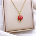 Gold rotating evil eye necklace featuring a vibrant red and black ladybug pendant - Rotatable Insect Style (XL2367) / Gold