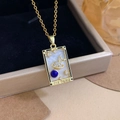 Golden tarot 'The World' pendant necklace with moon and stars in a jewelry box - Gold - The World (XL2764)