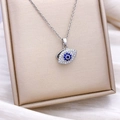 Rotating blue Evil Eye pendant necklace with white crystals on a silver titanium steel chain - Silver