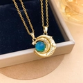 Golden crescent moon necklace with a teal bead and star detail in a jewelry box - Moon Mood Stone Magnetic Gold