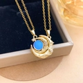 Golden sun and moon necklace with blue celestial bead in a black jewelry gift box - Moon Cat's Eye Magnetic Gold