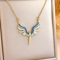 Golden angel wing necklace with blue and white zircon stones in a jewelry box - Blue Angel (XL309) / Gold