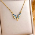 Golden Angel Wing Necklace with blue and white gradient crystals on a beige box - Blue Small Angel (XL1602) / Gold