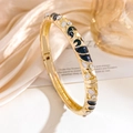 Golden hinged bangle with black and white enamel wave patterns and shimmering rhinestones - Gold Black