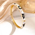 Vintage gold-plated hinge bracelet with white enamel and black floral patterns - White