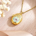 Golden oval locket necklace with Evil Eye and Hamsa Hand design on silk background - Hamsa Hand Evil Eye Light Blue (XL5002)