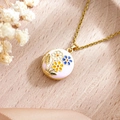 Pink enamel evil eye photo locket necklace with gold floral details on wood background - Daisy Pink Round (XL5023)
