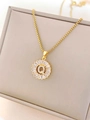 Macro shot of gold sunburst pendant with letter Q and sparkling zircon stones - Letter Q / Gold