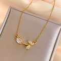 Elegant gold tulip pendant necklace with pear-shaped white zircon on pink silk fabric - White Tulip Necklace Gold