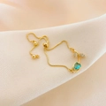 Adjustable gold titanium bracelet with a blue teardrop stone and diamond leaf accents - Blue Tulip Bracelet Gold