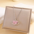 Elegant silver heart necklace featuring a pink crystal pendant in a saturn-style ring - Pink Heart Planet Necklace (Silver Chain)