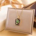 Vintage gold tarot necklace with black enamel World card pendant on soft beige background - World Style (XL2258) - Gold