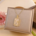 Gold zodiac necklace with Aquarius pendant and pink enamel inlay surrounded by crystals - Aquarius / Gold