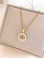 Golden titanium steel necklace featuring a round pendant with letter U and zircon stones - Letter U / Gold