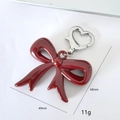 Burgundy acrylic bow keychain with silver heart clasp measuring 49mm by 68mm - Angola Red Bowknot Heart Buckle