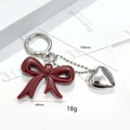 Detail view of burgundy acrylic bow and silver heart pendant keychain with dimensions - Angola Red Bowknot Heart